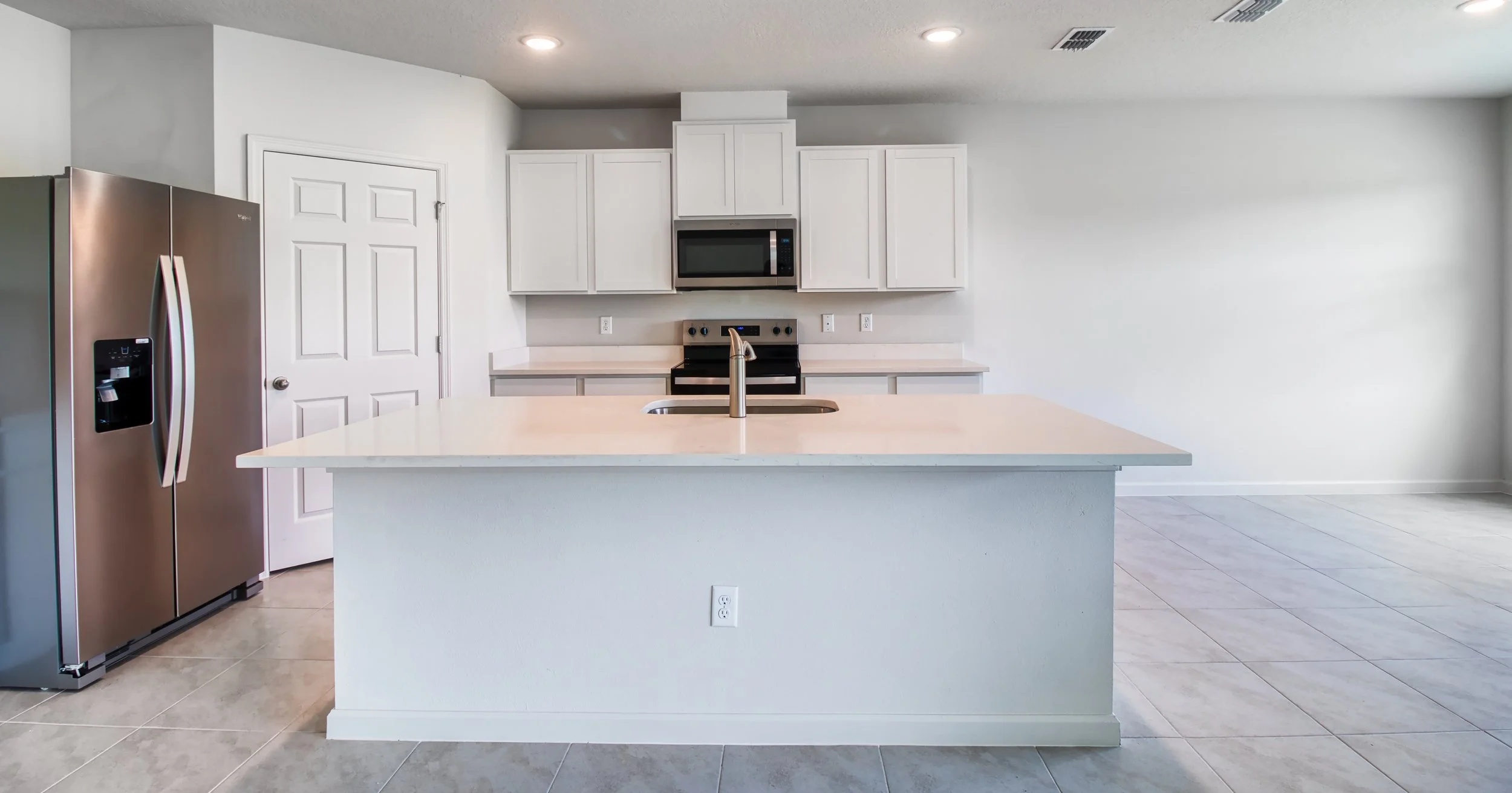 Kitchen island with quartz countertops in the Madison Plan