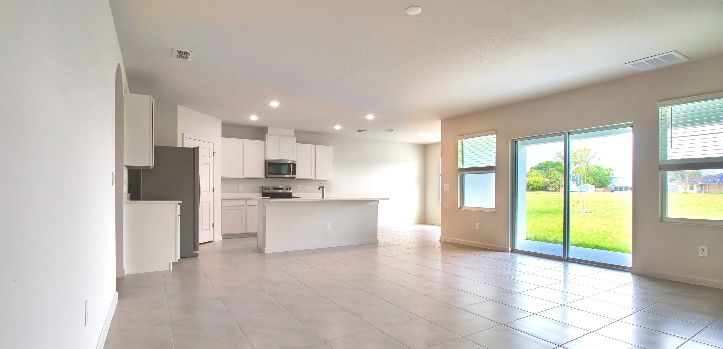 Open-concept kitchen and living area in the Madison Plan