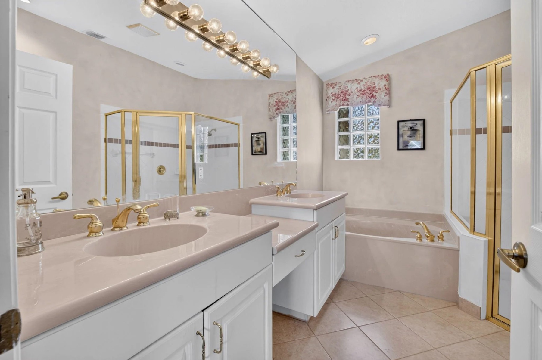 Primary Suite With Dual Vanities & a Roman Tub