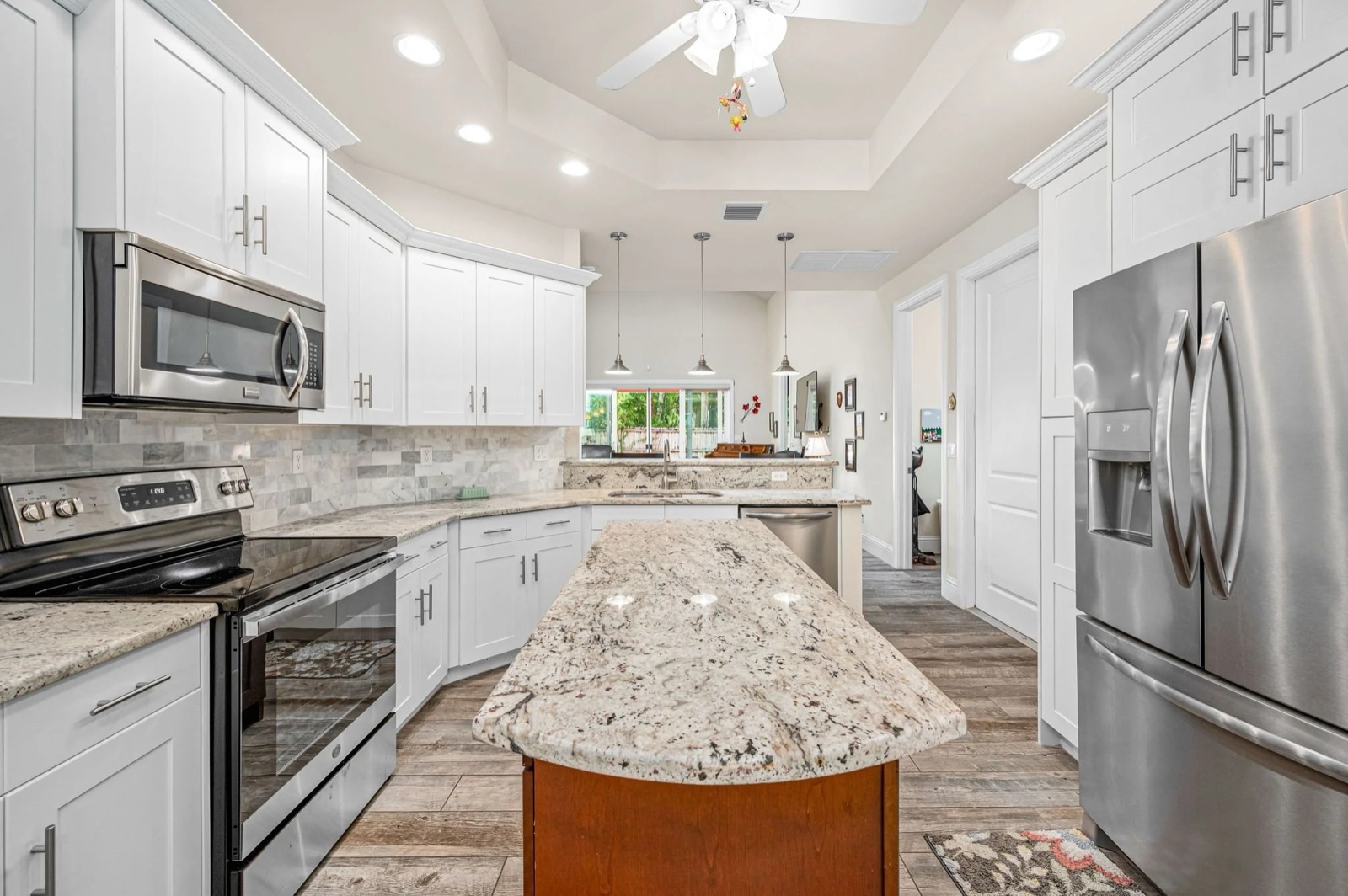 Professional real estate photo of a bright kitchen with an island