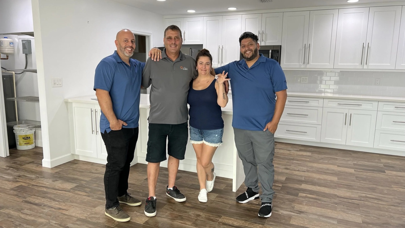 The Alfredo Rivera Group celebrating with clients at a home closing